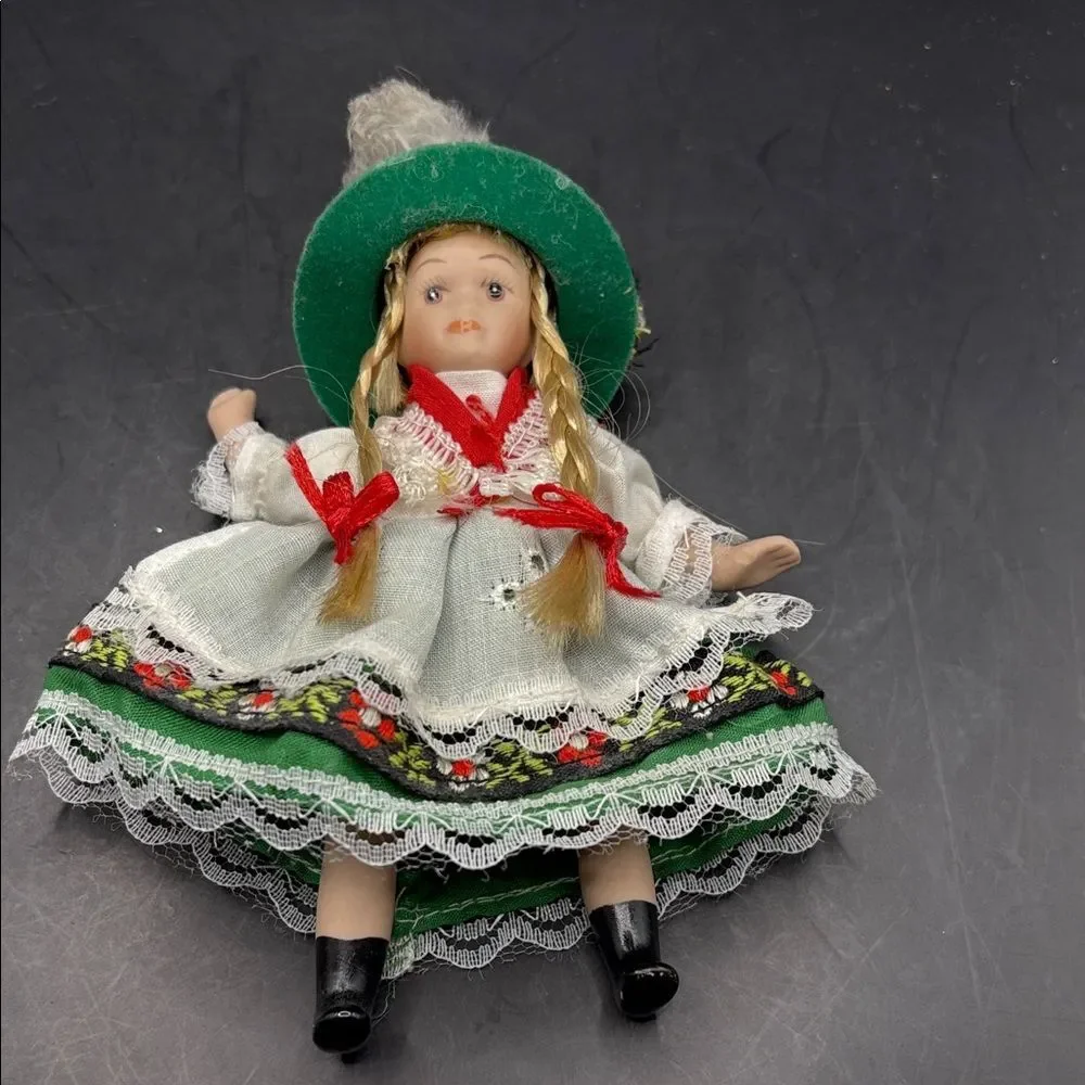 Traditional vintage porcelain doll with Green Hat and Dress